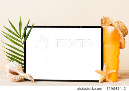 Flat lay composition with tablet and beach accessories on colored background. Tablet computer with blank screen mock up with copy space Flat lay composition with tablet and beach accessories on colored background. Tablet computer with blank screen mock up with copy space 139845442