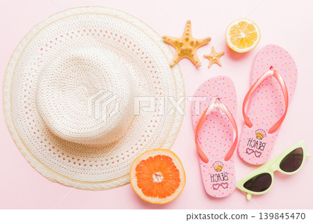Top view of various seashells placed near colorful fruit and stylish summer accessories on table background. Summer concept. Flat lay. Top view with copy space for text Top view of various seashells placed near colorful fruit and stylish summer accessories on table background. Summer concept. Flat lay. Top view with copy space for text 139845470