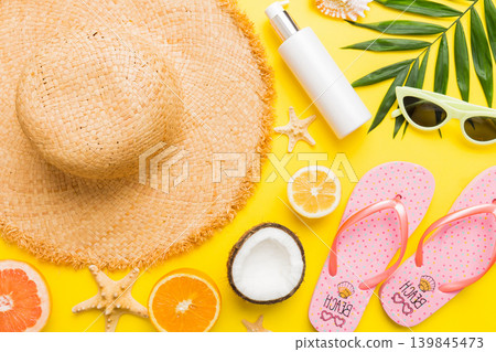 Top view of various seashells placed near colorful fruit and stylish summer accessories on table background. Summer concept. Flat lay. Top view with copy space for text Top view of various seashells placed near colorful fruit and stylish summer accessories on table background. Summer concept. Flat lay. Top view with copy space for text 139845473