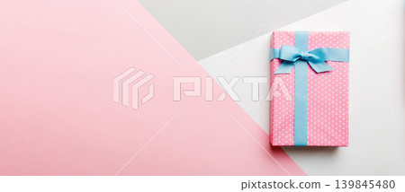 holiday handmade paper present tied blue ribbon bow top view with copy space. Flat lay holiday background. Birthday or christmas present. Christmas gift box concept with copy space 139845480