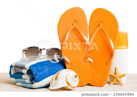 Stylish bag with beach accessories . Summer holiday concept. Top view of beach bag with sunscreen cream with space for text Stylish bag with beach accessories . Summer holiday concept. Top view of beach bag with sunscreen cream with space for text 139845494