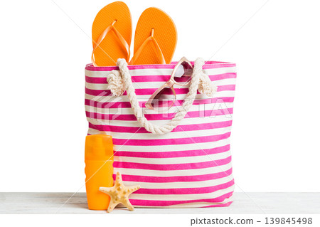 Stylish bag with beach accessories . Summer holiday concept. Top view of beach bag with sunscreen cream with space for text 139845498