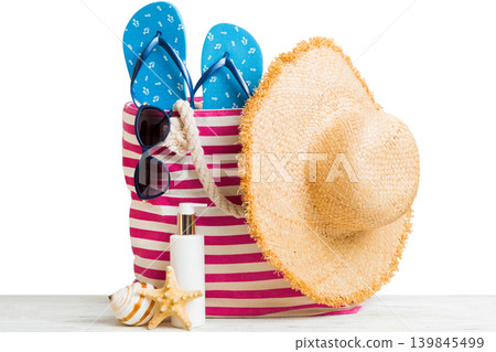 Stylish bag with beach accessories . Summer holiday concept. Top view of beach bag with sunscreen cream with space for text 139845499