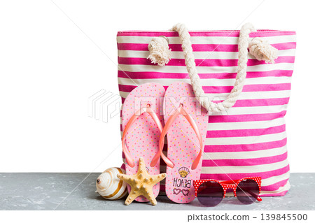 Stylish bag with beach accessories . Summer holiday concept. beach bag with straw hat with space for text Stylish bag with beach accessories . Summer holiday concept. beach bag with straw hat with space for text 139845500