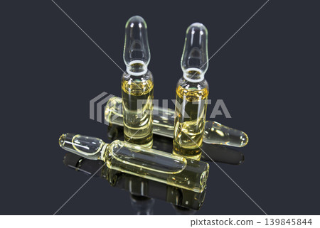 Medical glass ampoules with light yellow vaccine 139845844