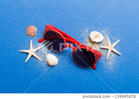 sunglasses with seashell lying on table background. Sunglasses on summer background. Top view flat lay with copy space for text sunglasses with seashell lying on table background. Sunglasses on summer background. Top view flat lay with copy space for text 139845878