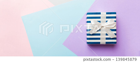 holiday handmade paper present tied white ribbon bow top view with copy space. Flat lay holiday background. Birthday or christmas present. Christmas gift box concept with copy space holiday handmade paper present tied white ribbon bow top view with copy space. Flat lay holiday background. Birthday or christmas present. Christmas gift box concept with copy space 139845879