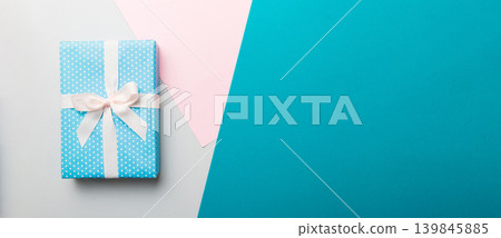 holiday handmade paper present tied white ribbon bow top view with copy space. Flat lay holiday background. Birthday or christmas present. Christmas gift box concept with copy space holiday handmade paper present tied white ribbon bow top view with copy space. Flat lay holiday background. Birthday or christmas present. Christmas gift box concept with copy space 139845885
