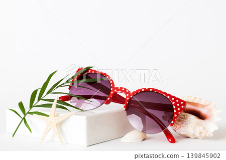 sunglasses with seashell lying on table background. Sunglasses on summer background. Top view flat lay with copy space for text sunglasses with seashell lying on table background. Sunglasses on summer background. Top view flat lay with copy space for text 139845902