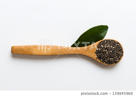 Wooden spoon and chia seeds on colored background, top view. Healthy Salvia hispanica Healthy superfood Wooden spoon and chia seeds on colored background, top view. Healthy Salvia hispanica Healthy superfood 139845968