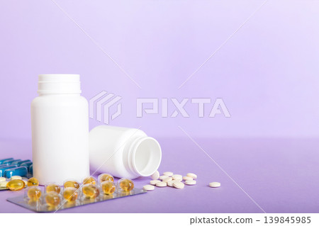 Medicine for treatment HIV infection. Pills and capsules and battle on the table. Different colorful tablets at colored background with copy space Medicine for treatment HIV infection. Pills and capsules and battle on the table. Different colorful tablets at colored background with copy space 139845985