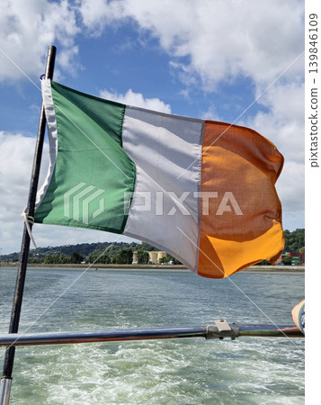 Irish Flag Waving Over River Background Irish Flag Waving Over River Background 139846109