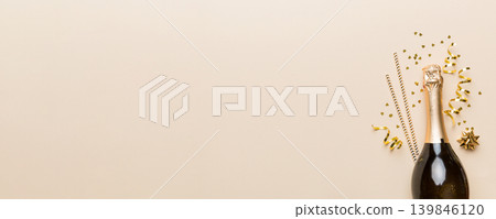 bottle of champagne with glasses and colorful confetti on colored background. top view flay lay bottle of champagne with glasses and colorful confetti on colored background. top view flay lay 139846120