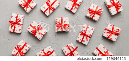 Valentine day composition Background: red gift box with bow and heart. Christmas present. View from above. Holday greeting card Valentine day composition Background: red gift box with bow and heart. Christmas present. View from above. Holday greeting card 139846123