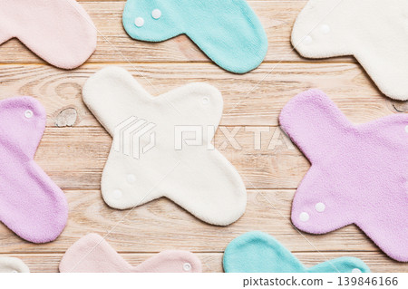 Eco-friendly reusable fabric women's pads. set of colorful bright reusable menstrual pads. zero waste woman periods concept top view with copy space Eco-friendly reusable fabric women's pads. set of colorful bright reusable menstrual pads. zero waste woman periods concept top view with copy space 139846166