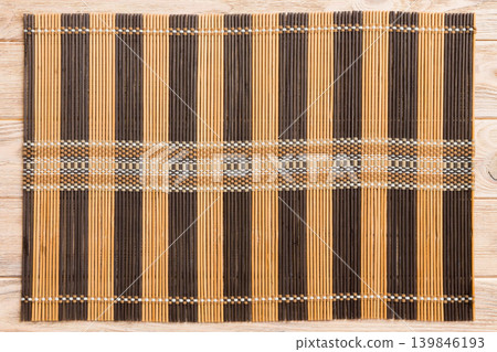 Top view of brown tablecloth for food on wooden background. Empty space for your design Top view of brown tablecloth for food on wooden background. Empty space for your design 139846193