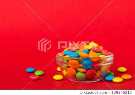 Multicolored candies in a bowl on a colored background. birthday and holiday concept. Top view with copy space Multicolored candies in a bowl on a colored background. birthday and holiday concept. Top view with copy space 139846213