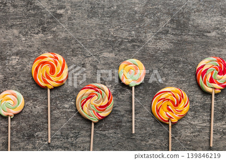 Set of colorful lollipops on colored background. Summer concept. Party Happy Birthday or Minimalist Concept Set of colorful lollipops on colored background. Summer concept. Party Happy Birthday or Minimalist Concept 139846219