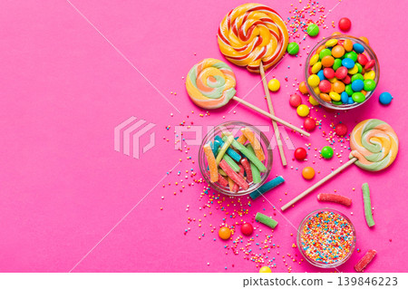 Tasty appetizing Party Accessories Happy Birthday Sweet. Different types of candies on colored background, copy space. Colorful birthday party background Tasty appetizing Party Accessories Happy Birthday Sweet. Different types of candies on colored background, copy space. Colorful birthday party background 139846223