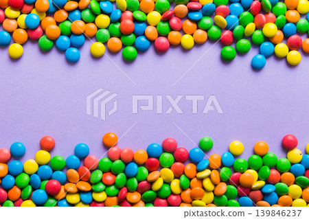 Mixed collection of colorful candy, on colored background. Flat lay, top view. frame of colorful chocolate coated candy 139846237