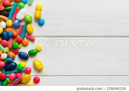 Mixed collection of colorful candy, on colored background. Flat lay, top view. frame of colorful chocolate coated candy 139846238