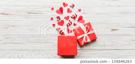 Happy valentines day opened heart shape gift box with small hearts, on colored background, valentines day card - top view concept Happy valentines day opened heart shape gift box with small hearts, on colored background, valentines day card - top view concept 139846263