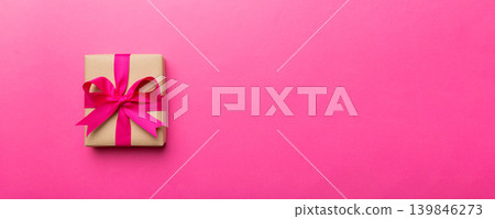 Holiday present box over colored background, top view. Copy space for design Holiday present box over colored background, top view. Copy space for design 139846273