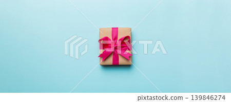 Holiday present box over colored background, top view. Copy space for design Holiday present box over colored background, top view. Copy space for design 139846274