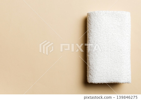Top view of white towels with copy space on colored background Top view of white towels with copy space on colored background 139846275