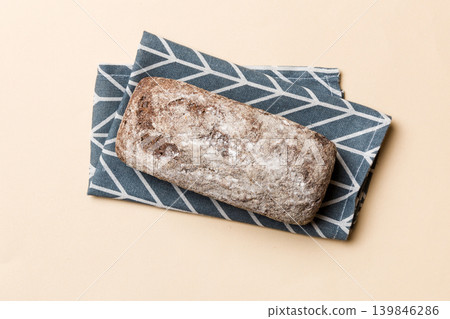 Fresh rye bread on napkin on rustic background, fresh bread top view Fresh rye bread on napkin on rustic background, fresh bread top view 139846286