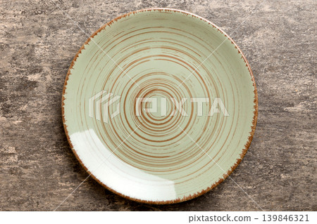 Top view of empty green plate on cement background. Empty space for your design Top view of empty green plate on cement background. Empty space for your design 139846321