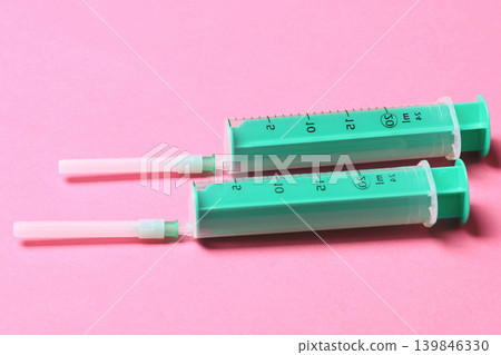 Top view of different syringes for injection on colorful background. Medical equipment concept with copy space Top view of different syringes for injection on colorful background. Medical equipment concept with copy space 139846330