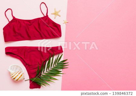 Traveler accessories, women summer bikini set swimsuit on table background with empty space for text. Travel vacation concept. Flat lay, top view Female sexy swimwear Traveler accessories, women summer bikini set swimsuit on table background with empty space for text. Travel vacation concept. Flat lay, top view Female sexy swimwear 139846372