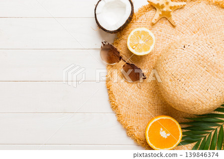 Top view of various seashells placed near colorful fruit and stylish summer accessories on table background. Summer concept. Flat lay. Top view with copy space for text Top view of various seashells placed near colorful fruit and stylish summer accessories on table background. Summer concept. Flat lay. Top view with copy space for text 139846374
