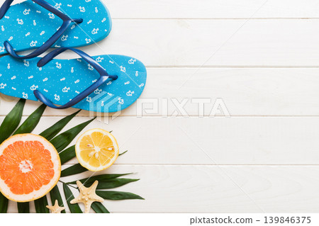 Top view composition of flip flops placed with beach accessories top view on table background. Tropical summer vacation concept Flat lay Top view composition of flip flops placed with beach accessories top view on table background. Tropical summer vacation concept Flat lay 139846375