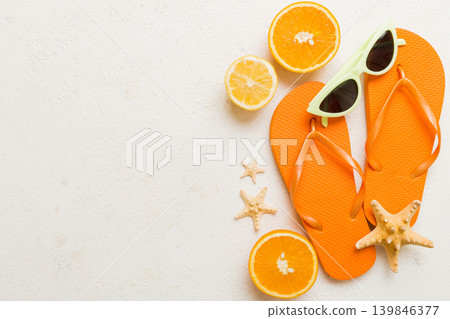 Top view composition of flip flops placed with beach accessories top view on table background. Tropical summer vacation concept Flat lay Top view composition of flip flops placed with beach accessories top view on table background. Tropical summer vacation concept Flat lay 139846377