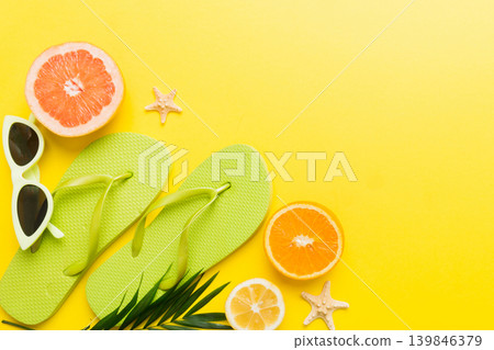 Top view composition of flip flops placed with beach accessories top view on table background. Tropical summer vacation concept Flat lay Top view composition of flip flops placed with beach accessories top view on table background. Tropical summer vacation concept Flat lay 139846379