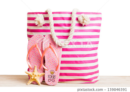Stylish bag with beach accessories . Summer holiday concept. beach bag with straw hat with space for text Stylish bag with beach accessories . Summer holiday concept. beach bag with straw hat with space for text 139846391