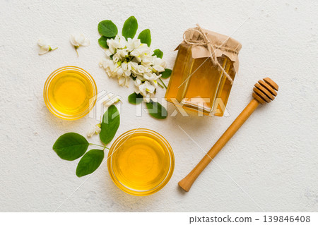 honey jar with acacia flowers and leaves. fresh honey top view flat lay honey jar with acacia flowers and leaves. fresh honey top view flat lay 139846408