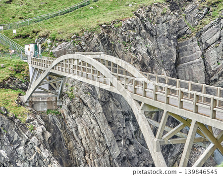 Concrete bridge over rugged rocky cliff Concrete bridge over rugged rocky cliff 139846545