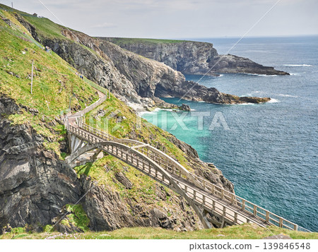 Coastal cliff path with footbridge and ocean view 139846548