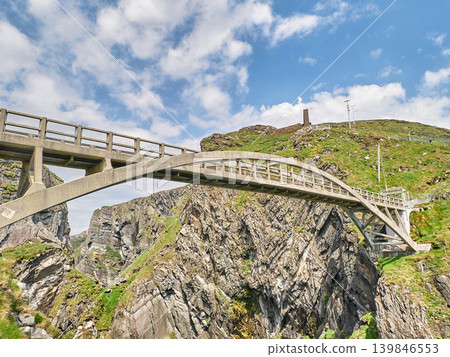 Concrete arch bridge over rugged mountain gorge 139846553