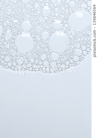 The texture of the foam of shower gel or soap suds or shaving foam. Macrophotography. Copy space 139846564