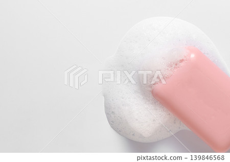 Pink soap with foam on a white background. Copy space Pink soap with foam on a white background. Copy space 139846568
