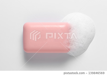 Pink soap with foam on a white background. Pink soap with foam on a white background. 139846569