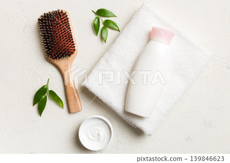 cosmetic for hair care, cream and towel on a colored background top view. flat lay cosmetic for hair care, cream and towel on a colored background top view. flat lay 139846623