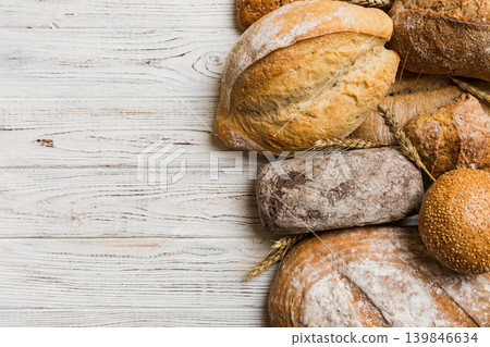 Homemade natural breads. Different kinds of fresh bread as background, top view with copy space Homemade natural breads. Different kinds of fresh bread as background, top view with copy space 139846634
