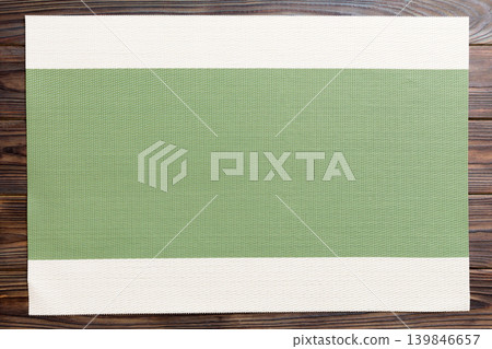 Top view of green tablecloth for food on wooden background. Empty space for your design Top view of green tablecloth for food on wooden background. Empty space for your design 139846657