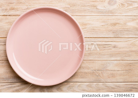 Top view of empty pink plate on wooden background. Empty space for your design 139846672