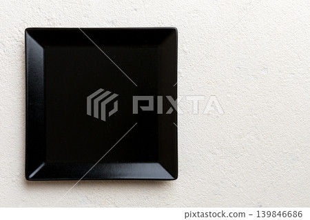Top view of empty square plate on cement background. Empty space for your design Top view of empty square plate on cement background. Empty space for your design 139846686